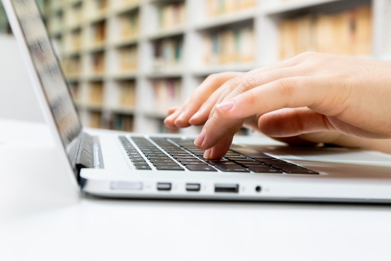 Hands typing on computer image